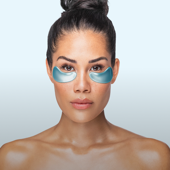 A woman using a Gold Repair Collagen Eye Mask.