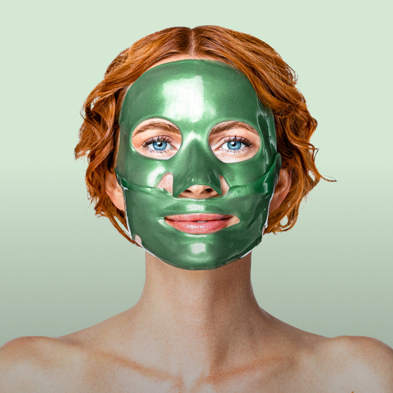 A woman using a Gold Repair Collagen Face Mask.