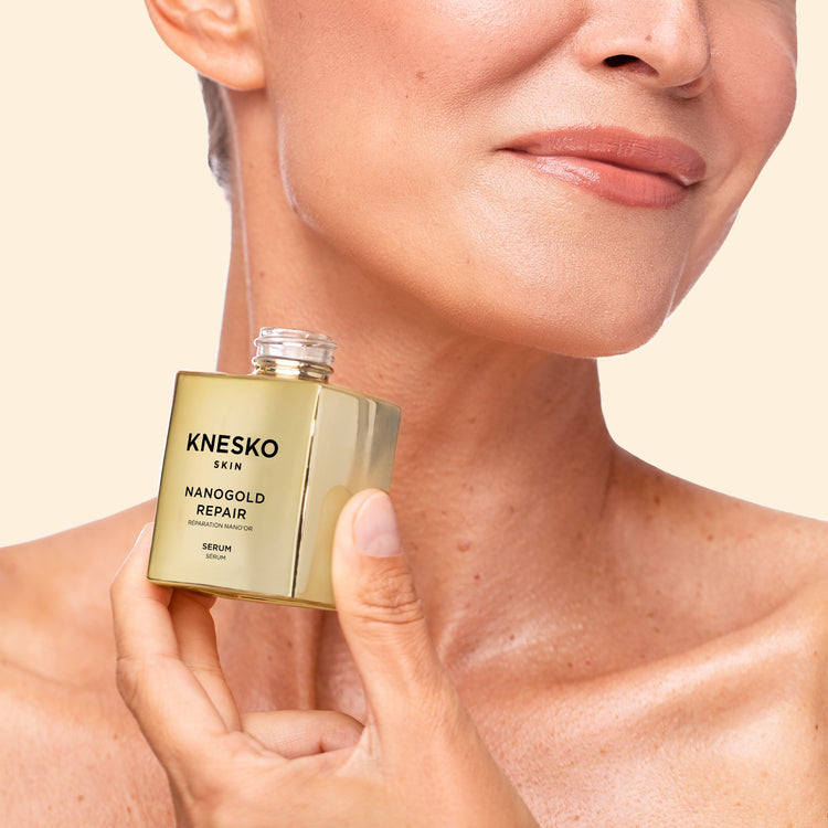 woman holding a jar of gold collagen serum