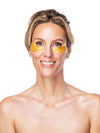 Woman wearing yellow eye masks on a white background