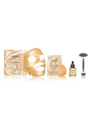 Knesko skincare product set including face mask, eye mask, roller, and serum on a white background