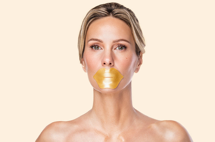 Woman wearing a gold lip mask on a beige background