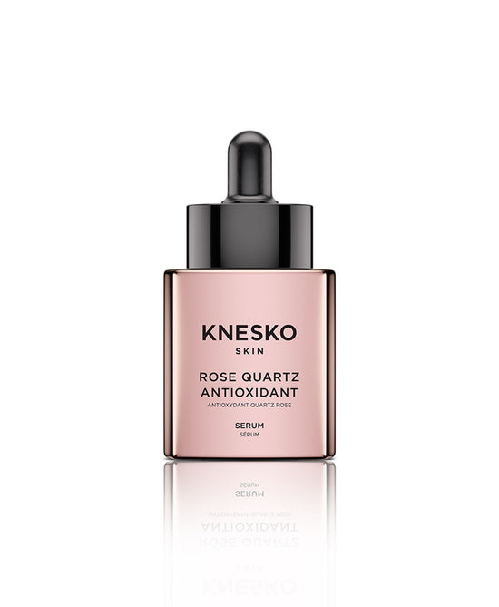 Rose quartz serum bottle on a white background