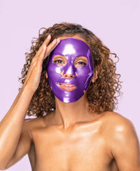 A woman using the Amethyst Hydrate Face Mask.