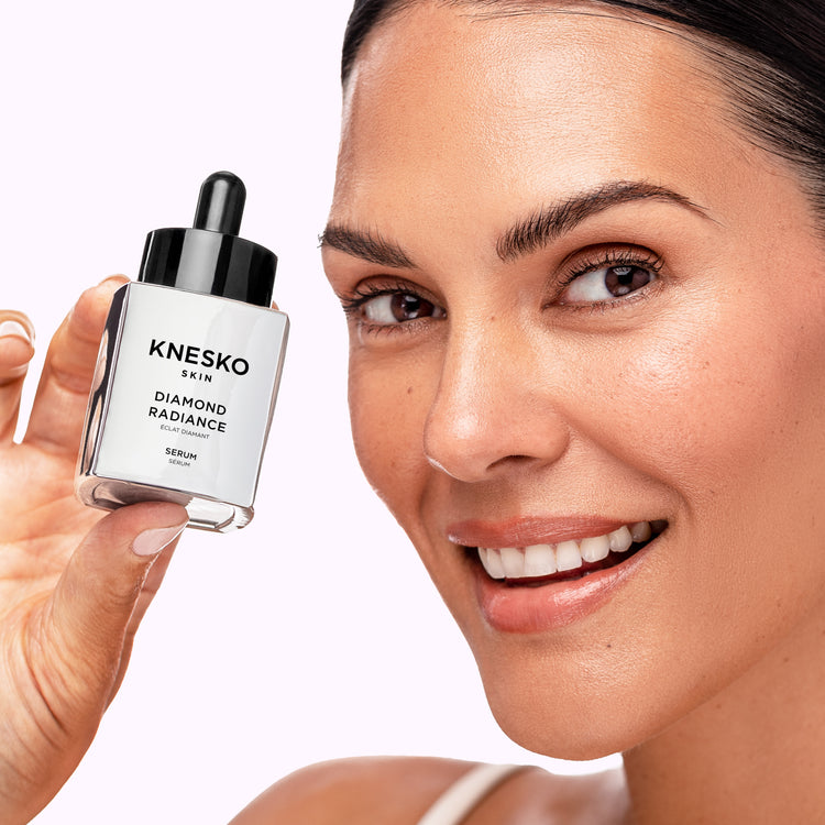woman holding a jar of diamond collagen serum