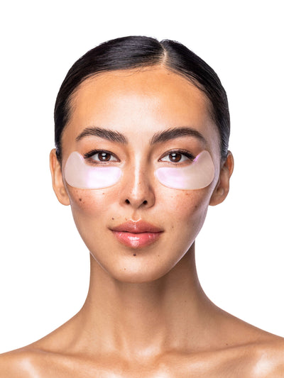 Woman wearing eye masks on a white background
