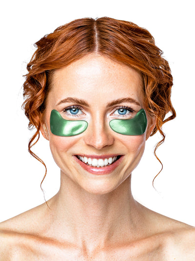 Woman wearing green eye masks on a white background
