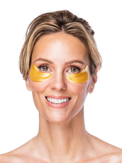 Woman wearing gold eye masks on a white background