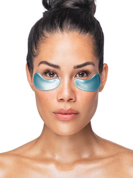 Woman wearing blue eye masks on a white background