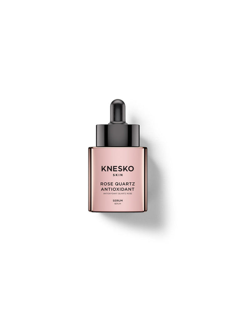 Knesko Skin Rose Quartz Antioxidant Serum in a rectangular dropper bottle with a metallic rose gold body and a black dropper cap, centered on a white background with a soft shadow.
