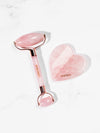 Knesko skincare tool set with pink heart-shaped roller and gua sha tool on a white background