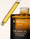 Knesko face oil bottle with dropper on a light background