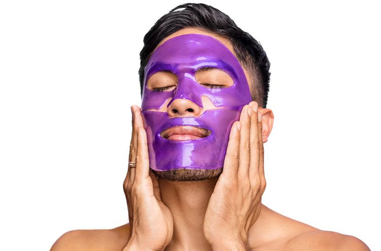 A man wearing a purple face mask on a white background
