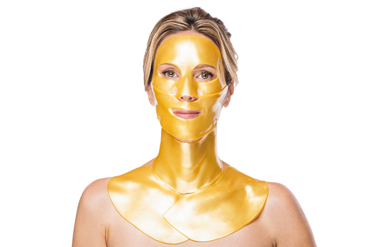 Woman with a gold face mask, gold neck mask and gold decollete mask on a white background