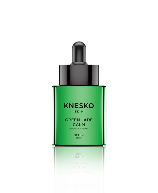 Green jade serum bottle on a white background