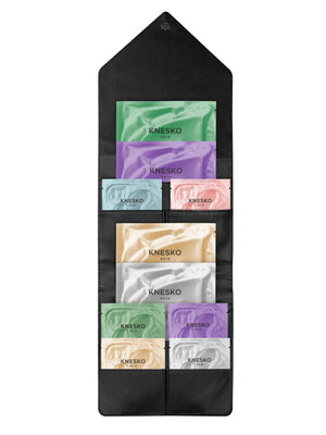 Set of Knesko skincare samples in a black holder on a white background