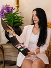 Woman holding an open black clutch with KNESKO face masks