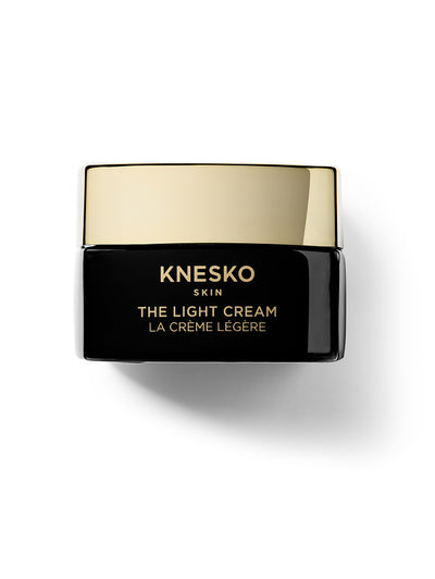 Knesko The Light Cream jar with gold lid on a white background