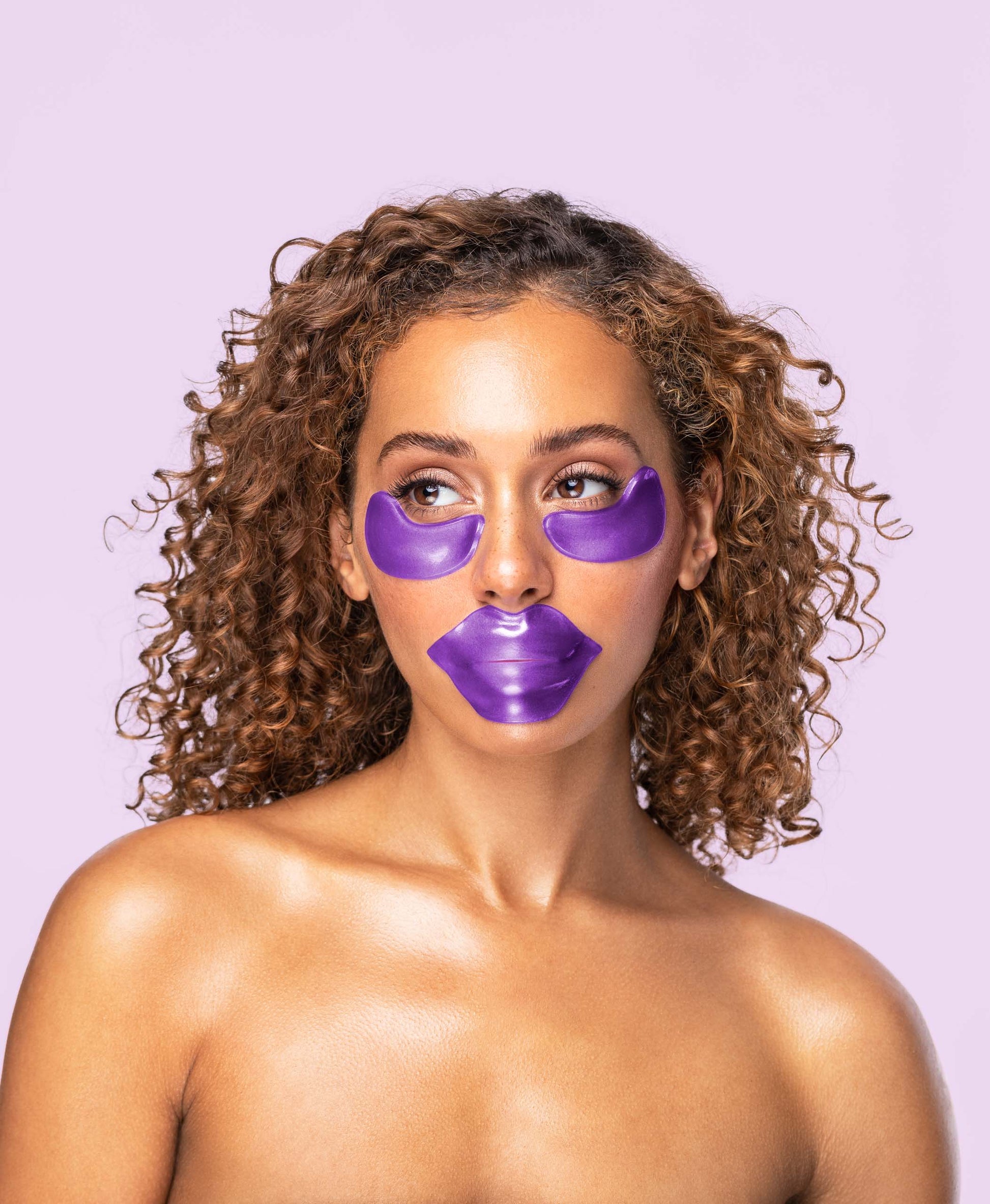 A woman using eye and lip masks from the Amethyst Hydrate collection.