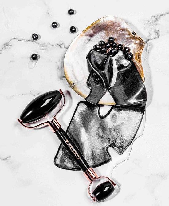 black pearl mask and gemstone roller on table