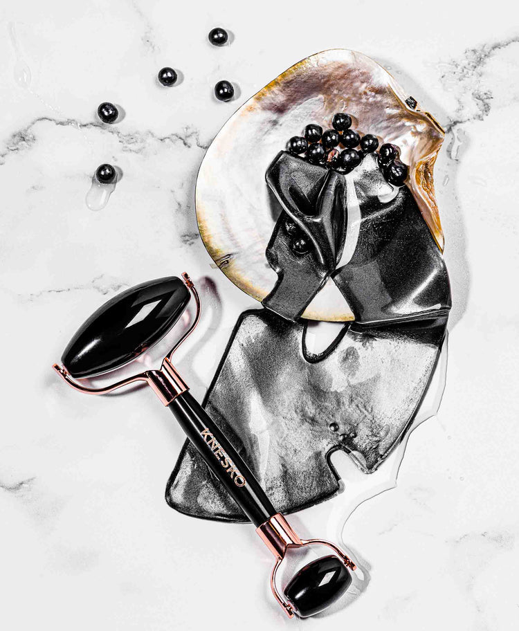 black pearl mask and gemstone roller on table
