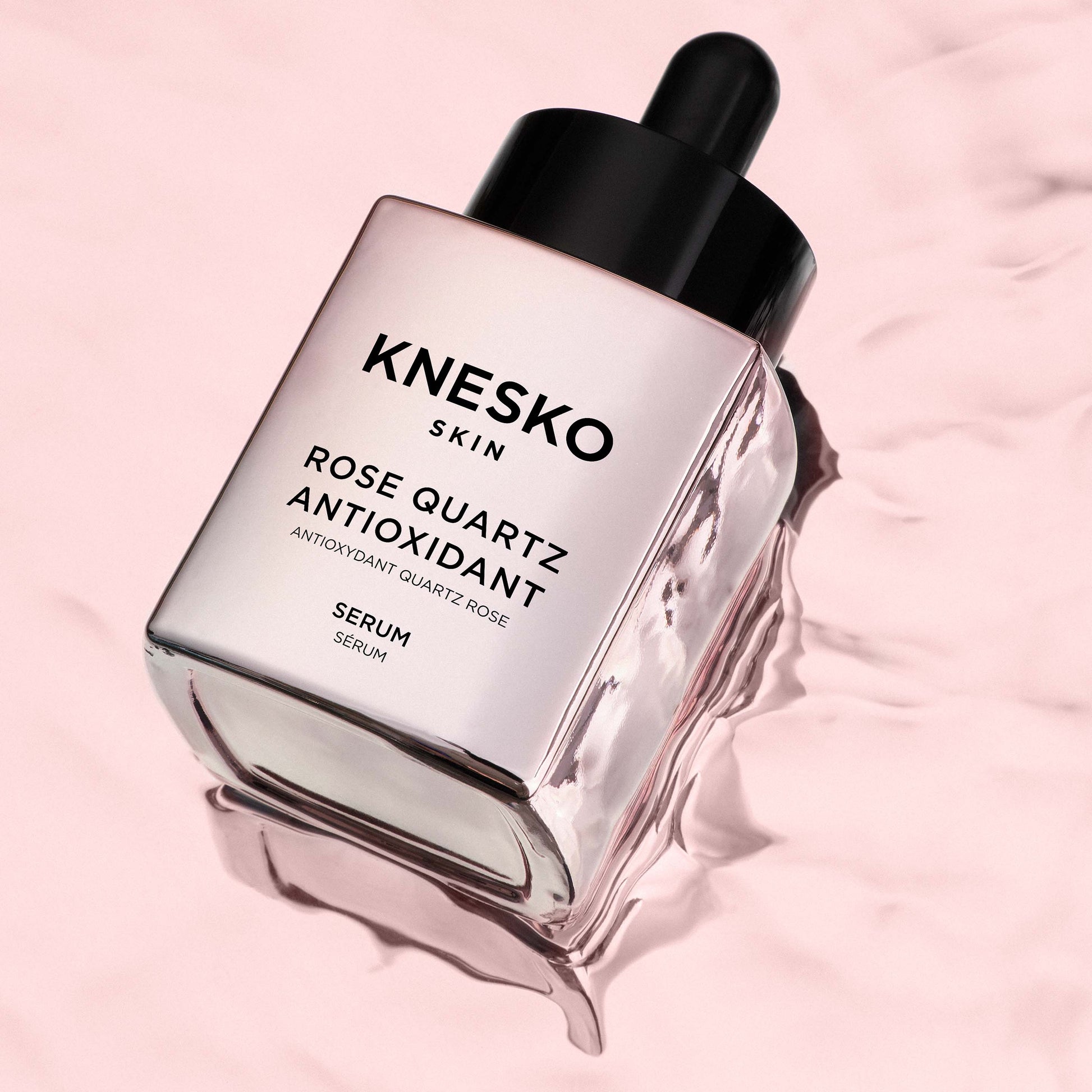 pink serum bottle that says knesko skin rose quartz antioxidant serum.