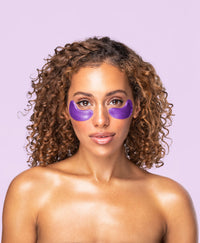 A woman using an Amethyst Hydrate Collagen Eye Mask.
