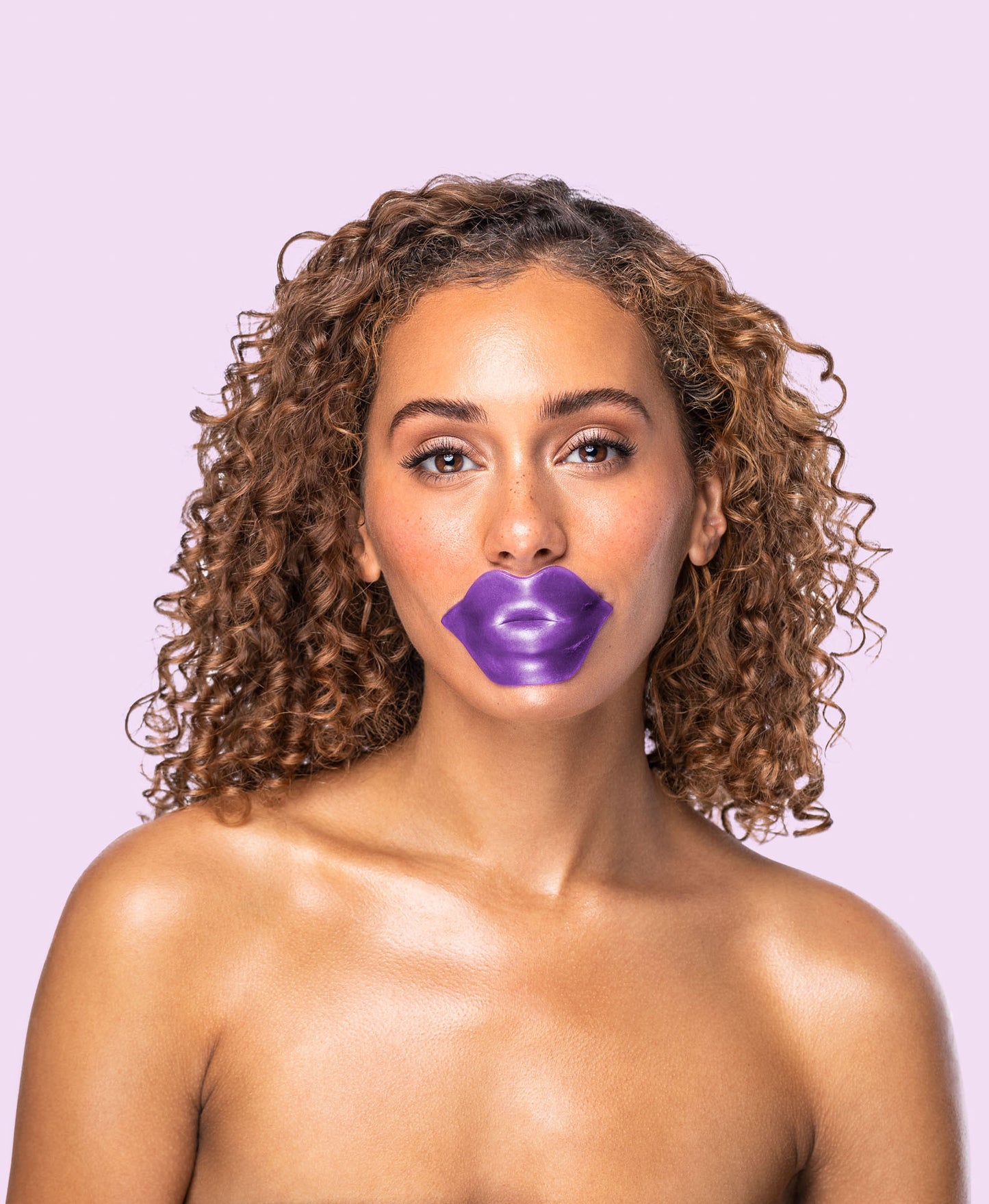 A woman using an Amethyst Hydrate lip mask.