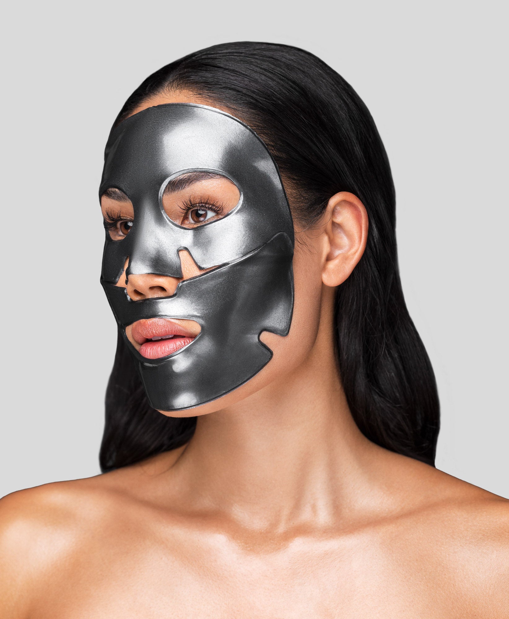 A woman using a Black Pearl Detox Collagen Face Mask