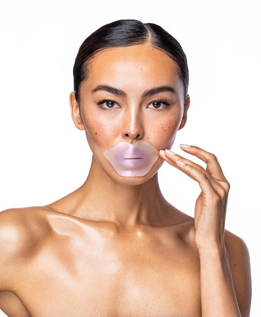 A woman using a Diamond Radiance Lip Mask.