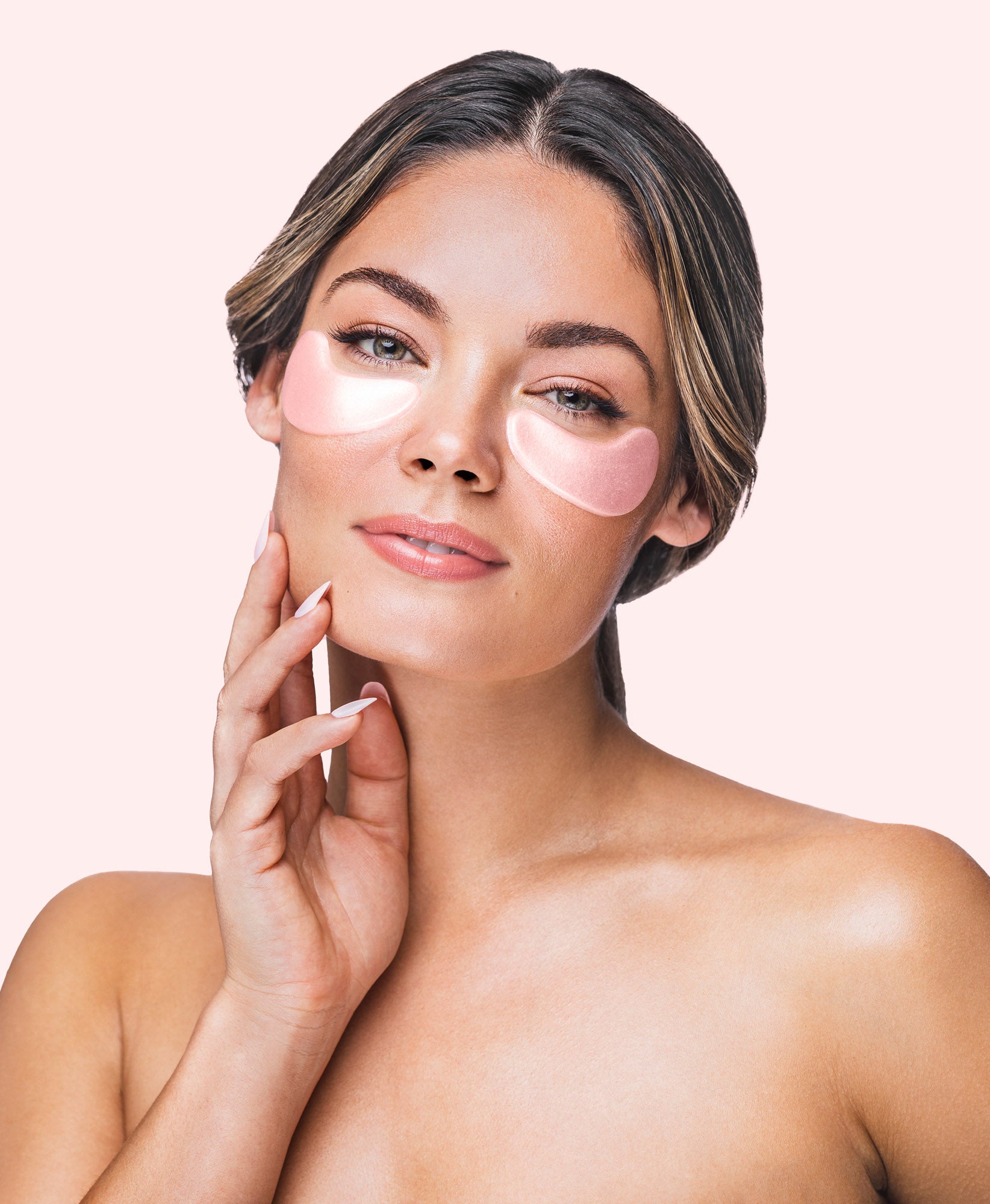 A woman using the Rose Quartz Antioxidant Collagen Eye Mask.