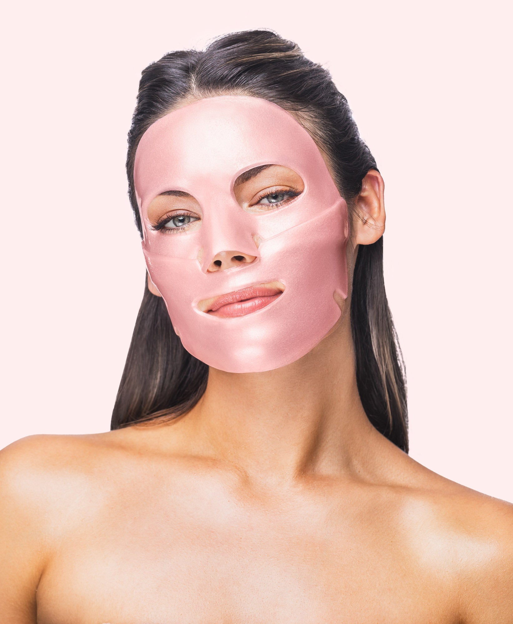 A woman using a Rose Quartz Antioxidant Collagen Face Mask.