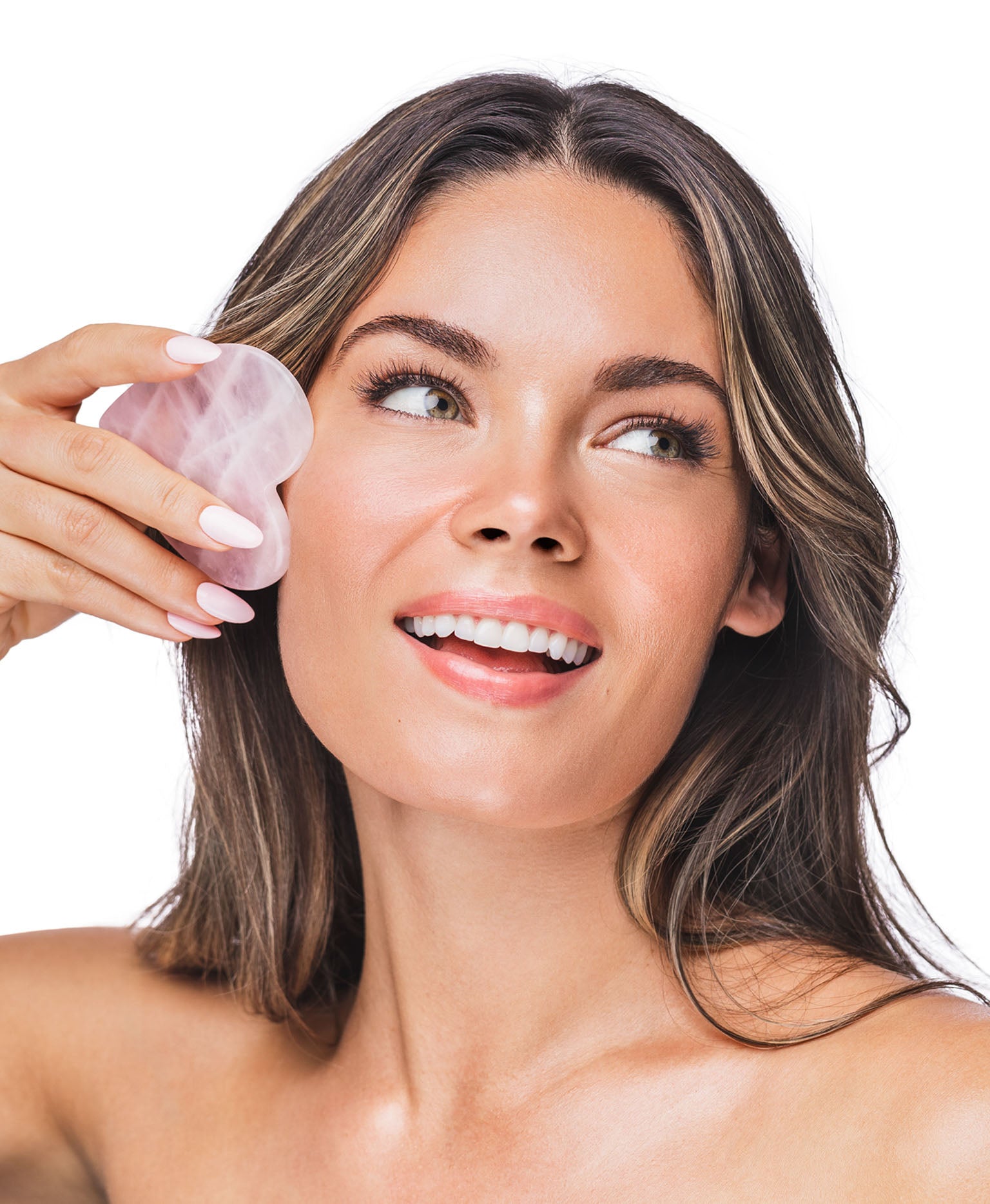 A woman using a Rose Quartz Gua Sha.