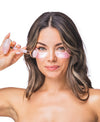 A woman using the Rose Quartz Antioxidant Collagen Mask & Rose Quartz Roller Set.